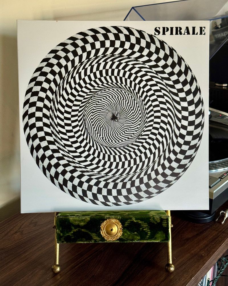 Vinyl copy of Spirale’s self-titled album sitting on a velvet Victorian photo stand. The record plays on a turntable in the distance. 


#nowspinning
#prog
#jazz