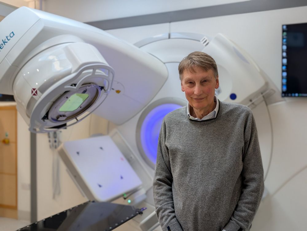 Professor Adrian Crellin with a state-of-the art linear accelerator (LINAC) radiotherapy machine at Leeds Teaching Hospitals NHS Trust. Credit: University of Leeds.  