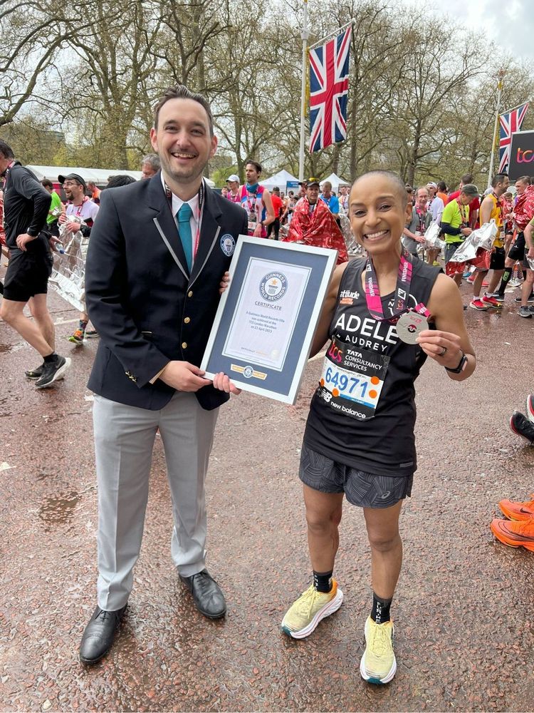 Adele Roberts receiving her Guinness World Record award after setting the Guinness World Record time for running a marathon with a stoma