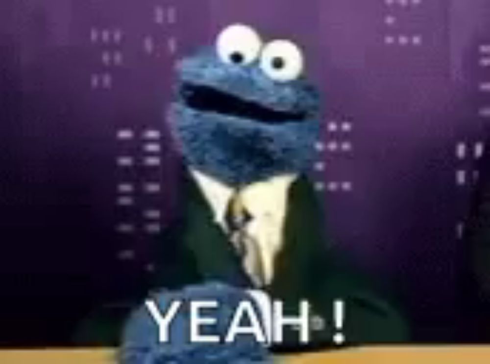 cookie monster is wearing a suit and tie and saying yeah .