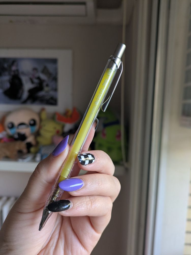 A yellow Pentel Orenz mechanical pen