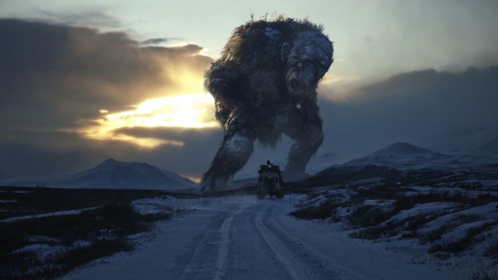 A massive troll in icy Norway standing over a truck.