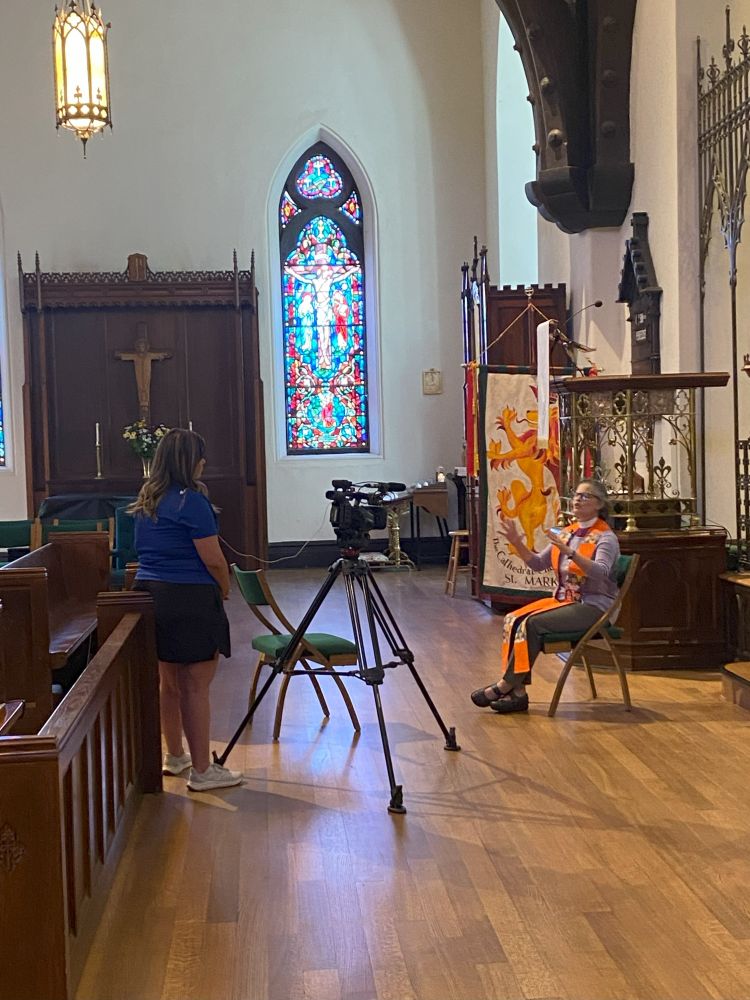 The bishop being interviewed in the chancel crossing of the cathedral
