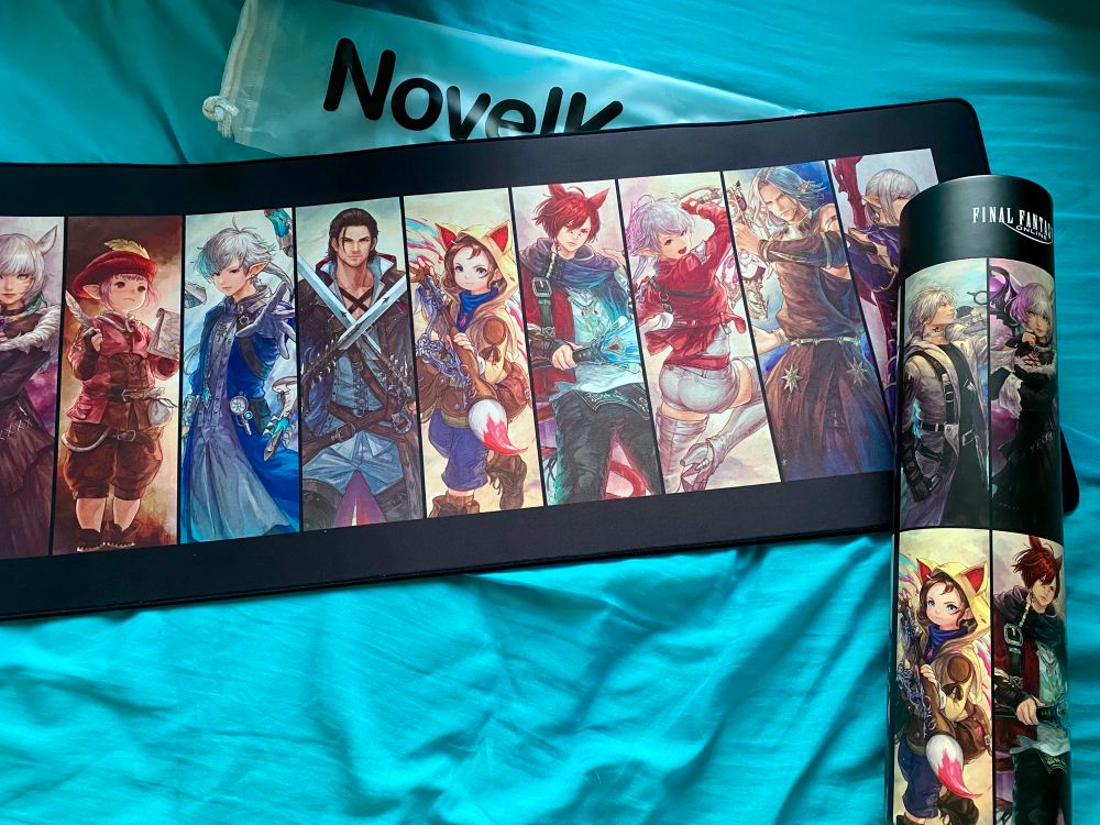The Final Fantasy XIV x NovelKeys Scions of the Seventh Dawn Deskpad laid out next to its packaging