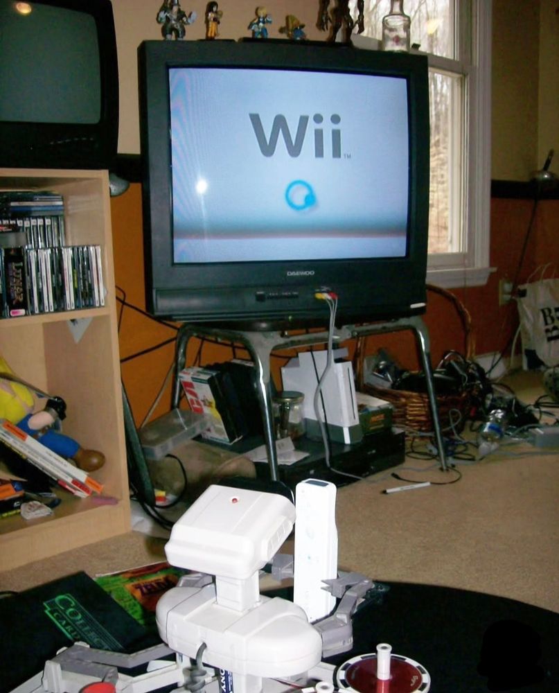 ROB the Robot playing Nintendo Wii in a retro 2007 gamer's bedroom.