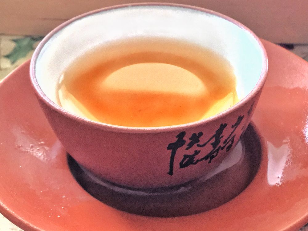 photograph of a sunrise in a tea cup