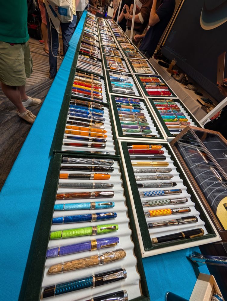 A table with beautifully colorful fountain pens on display.