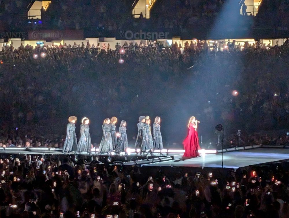 Taylor Swift Eras tour folklore era, berry dress followed by some of her coven dancers
