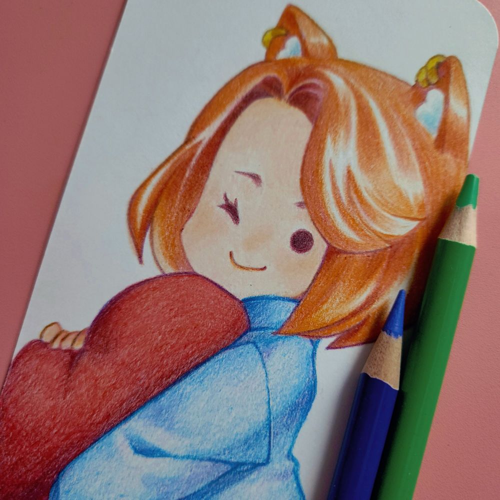 Pencil crayon drawing of a chibi girl with fox ears. She's wearing a blue sweater and clutching a heart shaped pillow, while winking at the viewer.