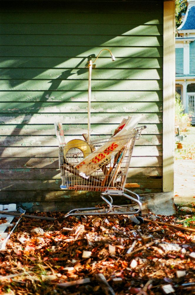 A shopping outside cart full of junk. 