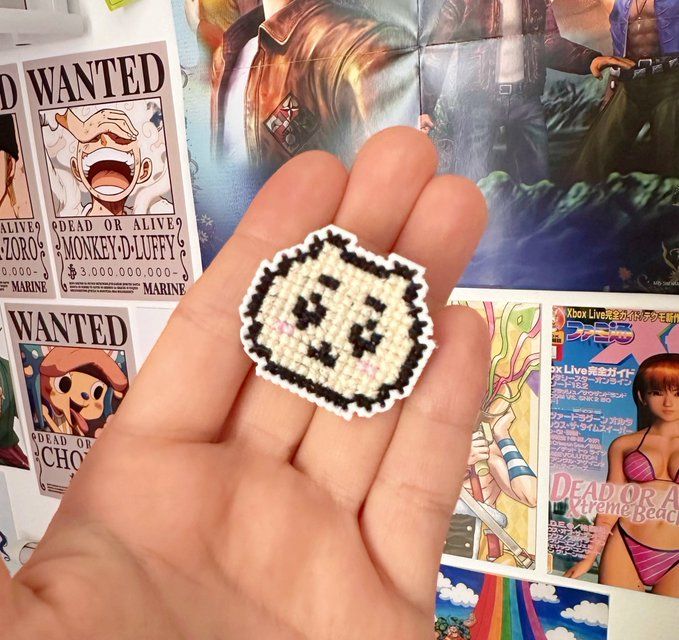 a small cross-stitch of chiikawa's face.