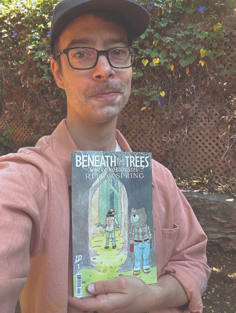 Patrick holding issue 1 of Beneath the Trees Where Nobody Sees - Rite of Spring