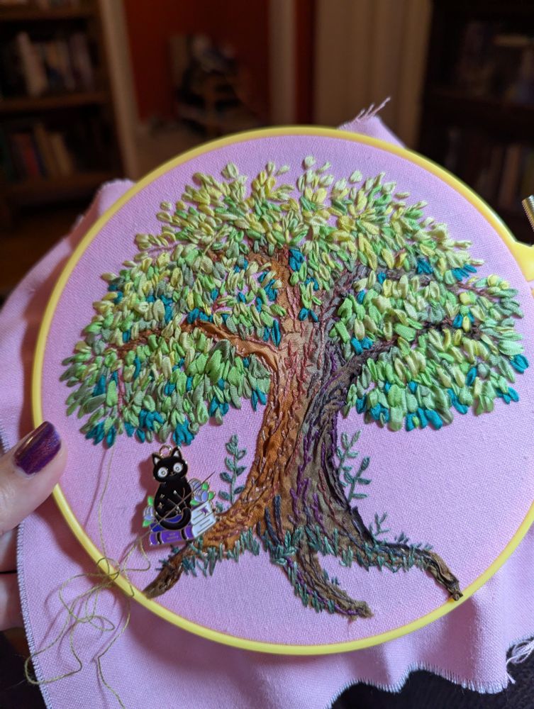 An embroidered tree made of silk ribbons and cotton embroidery floss using a variety of colors and stitches 