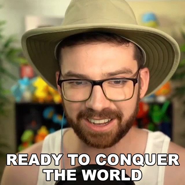 a man with a beard wearing a hat and glasses says ready to conquer the world