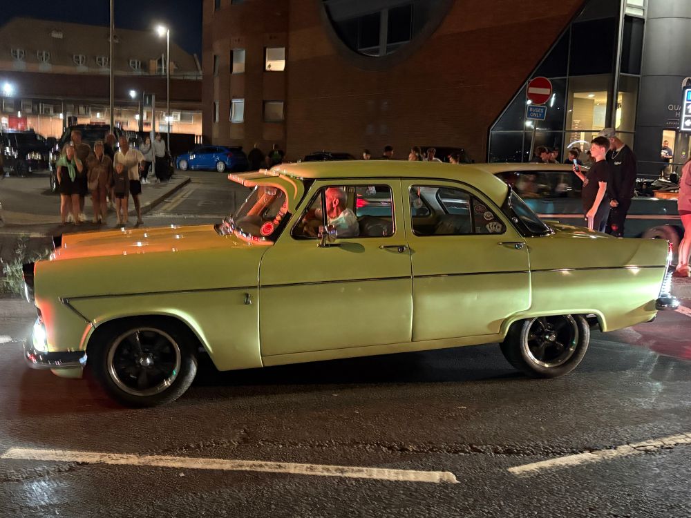 Yellow Americana style car where the back wheel isn’t fully visible because the chassis covers it 
