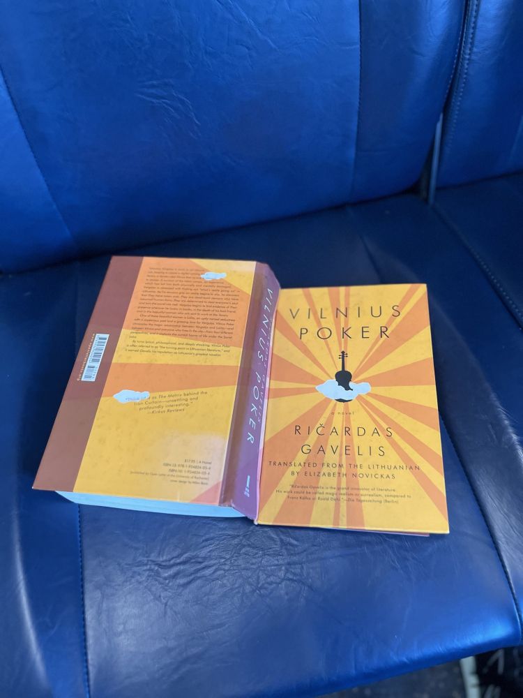 pic of Ricardas Gavielis' Vilnius Poker resting on a blue MARC train seat