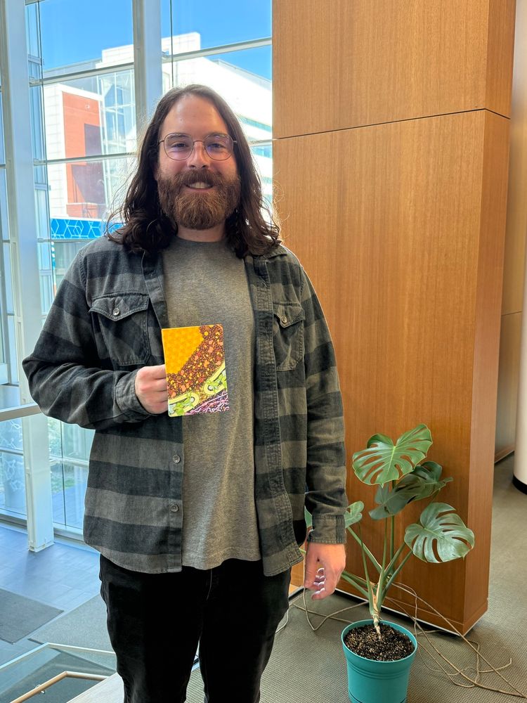 Scientist holding a painting by David Goodsell