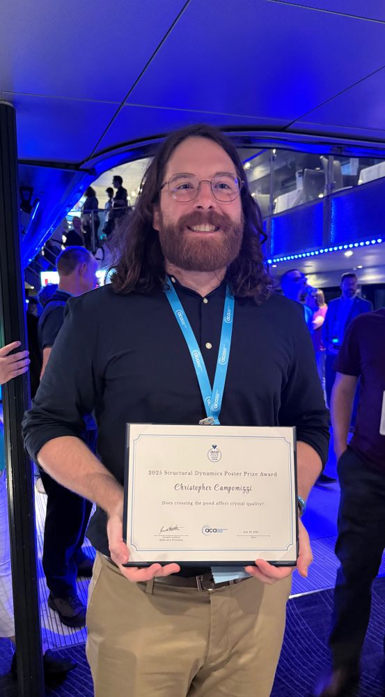 Scientist holding a poster prize
