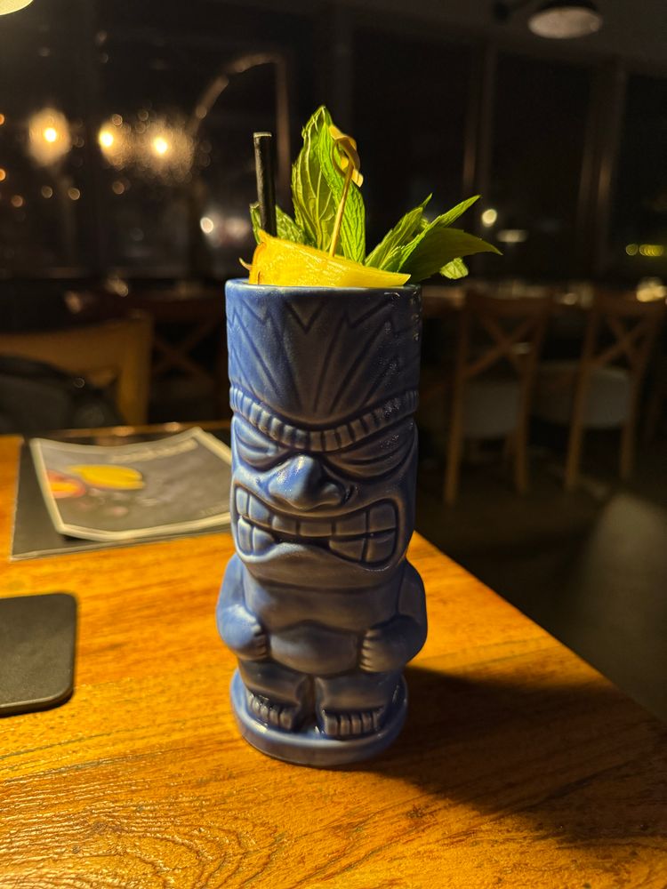 Tiki mug with mint and pineapple garnish visible 