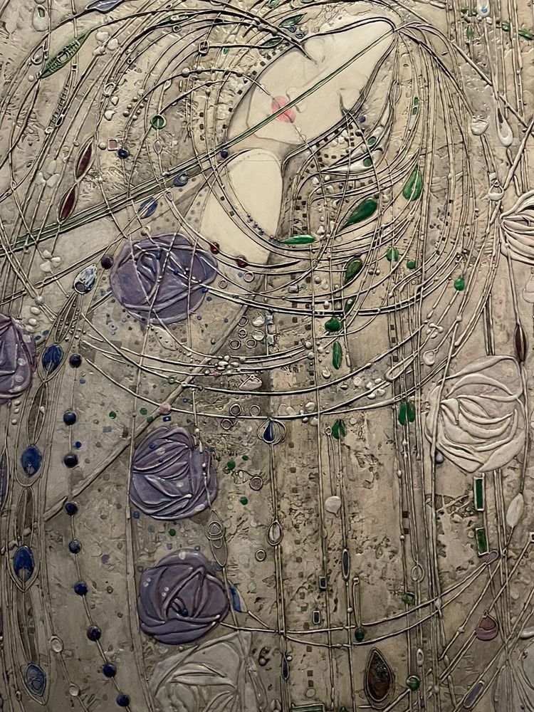 Artwork with stylised image of a white woman with long hair bending back with eyes closed among purple roses and silver organic lines on a silver background 
