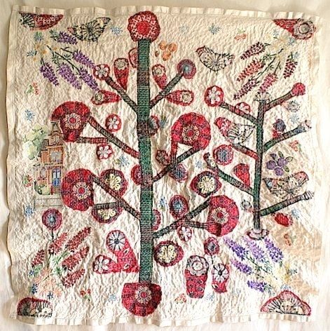 Textile artwork with stylised plant and red flower motifs on a cream background 