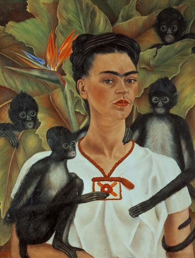 Painting featuring the upper half of a woman facing forwards looking outwards, the subject has dark hair tied up, wears a white blouse and is surrounded by four small monkeys and green foliage 