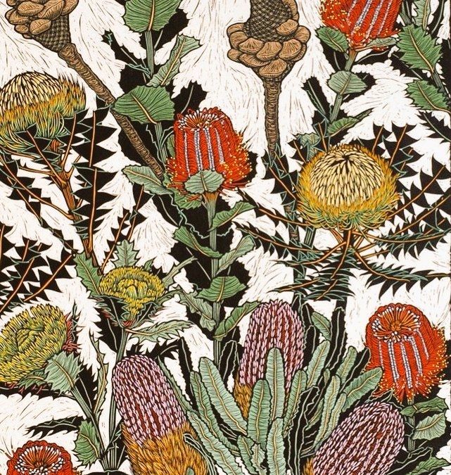 Print featuring red, pink and yellow flowers across the picture plane on green stems with spikey green leaves, all against a white background 