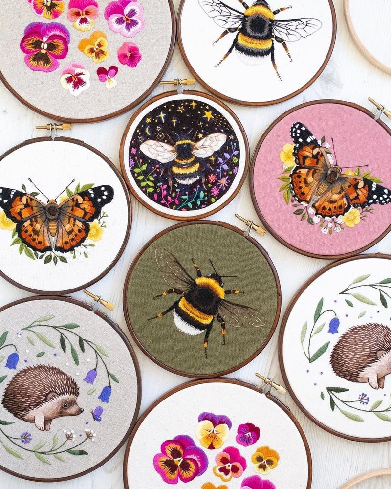 Photo of embroidetly hoops with embroidered images of butterflies,  flowers, hedgehogs and bumble beed