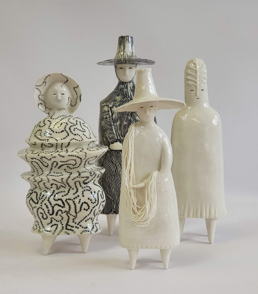 Photo featuring four stylised odd ceramic figures