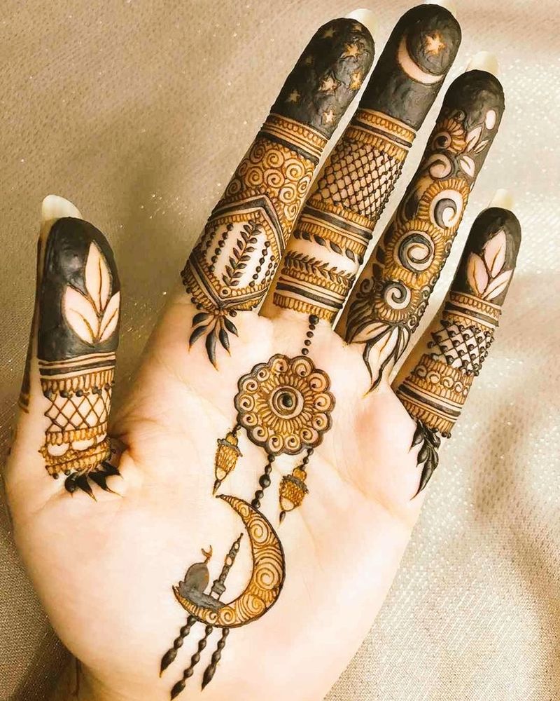 Photo of a hand with palm showing, with brown and black significant symbols and designs on the palm and fingers