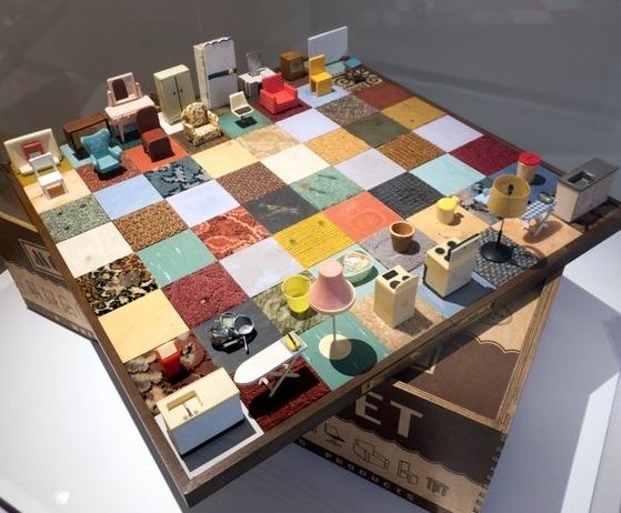 Photo of a chess set with domestic appliances as pieces, such as lamps, ironingboatds and stoves