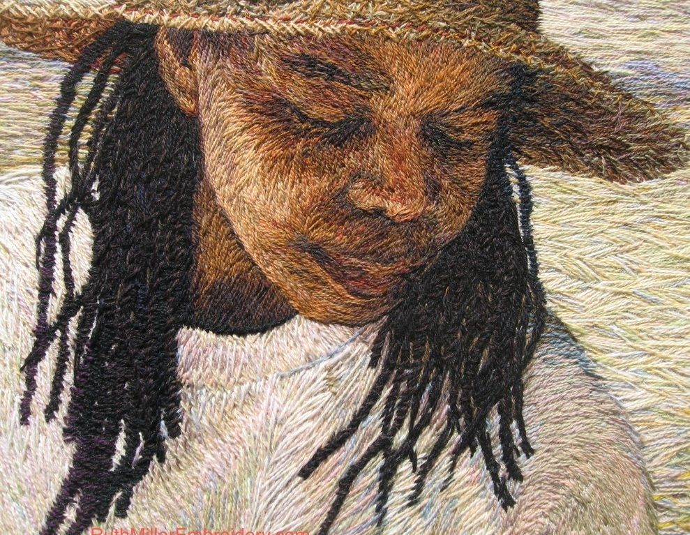 Pictorial textile artwork featuring the head and shoulders of a Black woman wearing a straw hat with long braided hair looking down