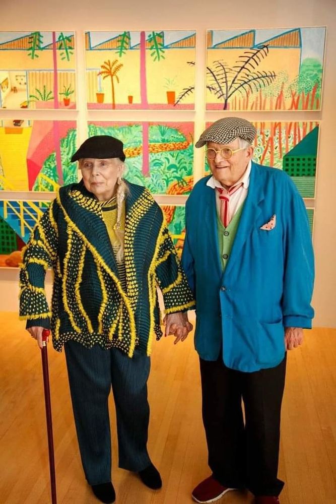 Photo featuring an elderly woman  and man holding hands in a interior space