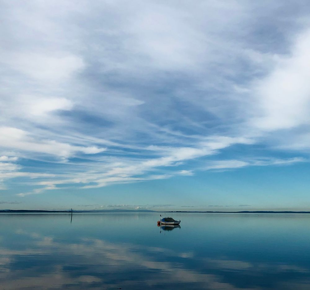 Oh, Monday mornin' Ohh Monday mornin' couldn't guarantee.
That Monday evenin' you would still be here with me…. 💙
My image of *Rhyll inlet on a completely all day with zero wind where the white wispy clouds above are reflected on the water below giving both water and sky a beautiful ethereal appearance with a single bait anchored centre of the image.
#BlueSkyMonday #Photography #Australia
#PhotographersOfBluesky #winter #sky #EastCoastKin  
#landscape #nature #writer 