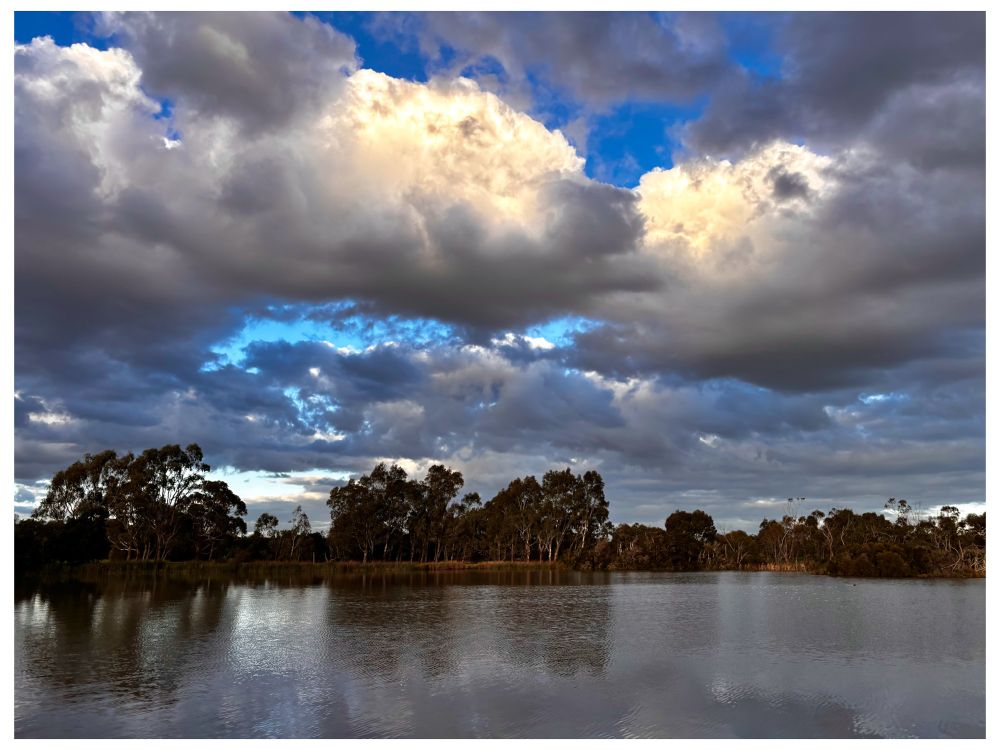 Some days the skies are so laden with wishes they can barely be contained. Heavy,filled with tears dust stars desperate longing childhood dreams heart ache & pain. Carrying the hope of everyone who’s ever looked to the skies wishing for change. Image of huge heavy puffy white and grey clouds over the lake interspersed with breaks of deep to light blue skies between the clouds. #BlueTue #EastCoastKin #Photography #Australia #wishes #landscape #winter #PhotographersOfBlueSky 