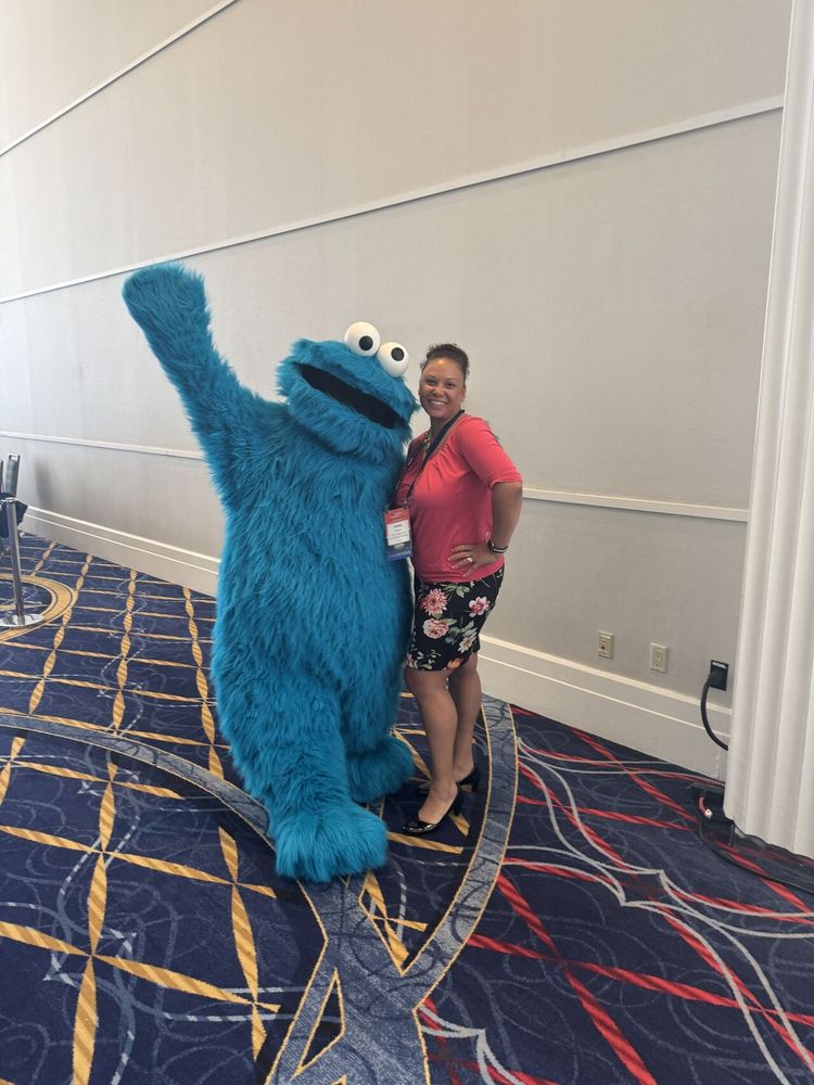 CHDI's Jeana Bracey poses for a photo with Cookie Monster