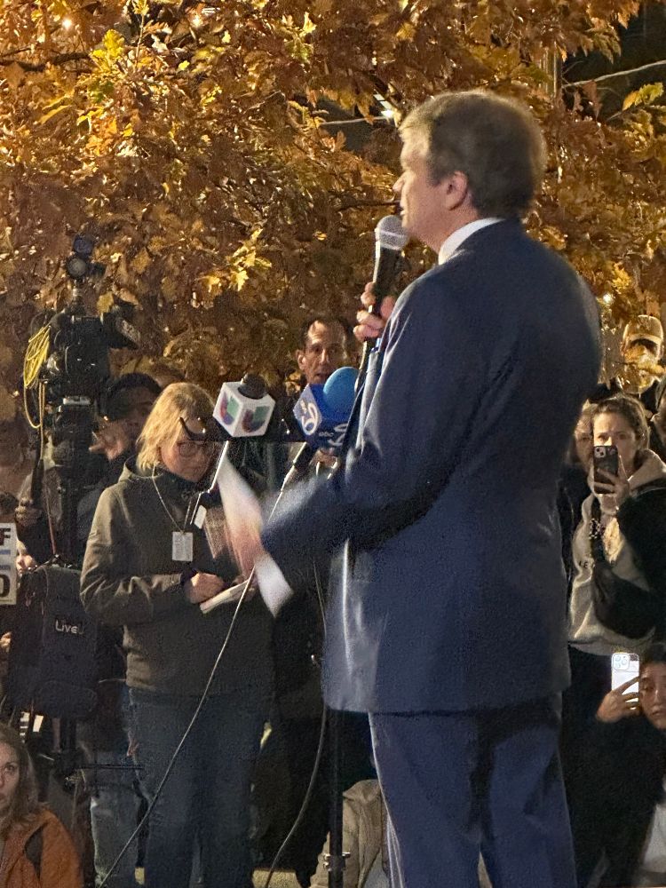 Rep. Mike Quigley giving brief remarks from the stage.