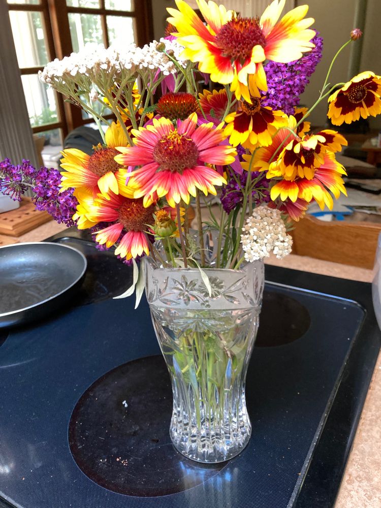 Hurried bouquet with blanket flowers (big red center and red petals tipped with yellow, shaped like daisies), coreopsis, butterfly bush and yarrow