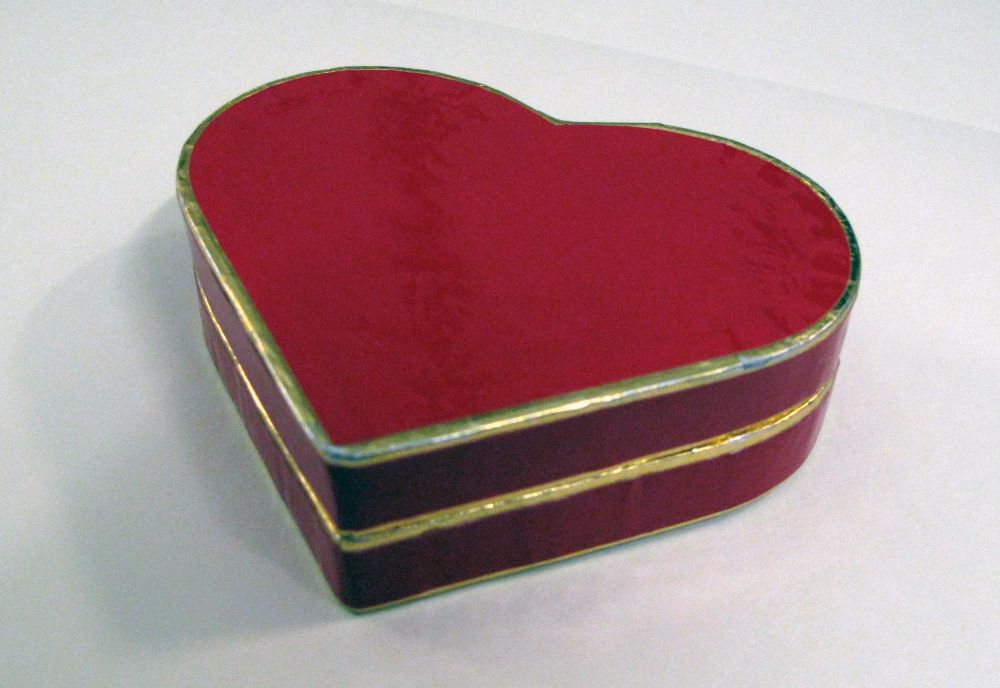 Red heart-shaped box with gold edging