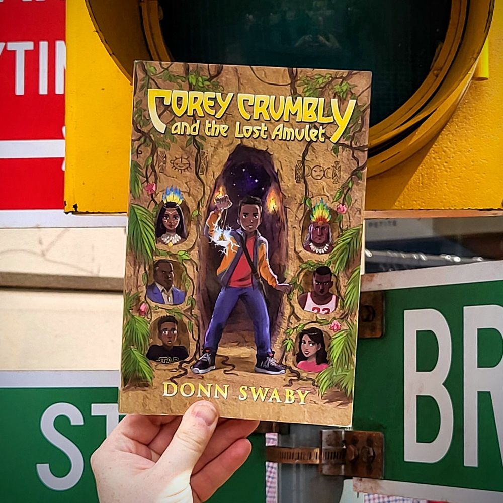 Photo of Corey Crumbly and the Lost Amulet in front of an American traffic light and street signs.