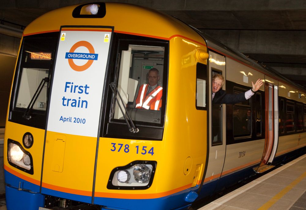 Picture of ex Mayor of London hanging out the window of a train. 