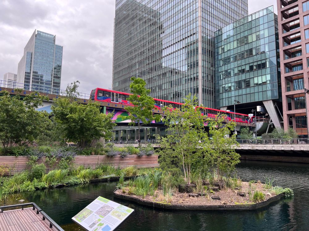 Photo of Canary Wharf water garden with DLR train in background 
