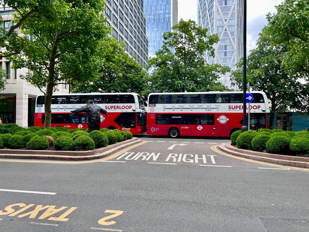 Two Superloop SL4 buses parked at the end of their route in Canary Wharf. 