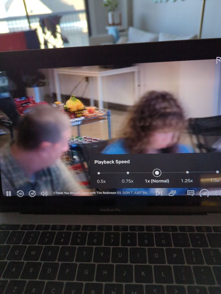 A poorly taken picture of a laptop playing "I Think You Should Leave with Tim Robinson" on Netflix with the playback speed option opened.