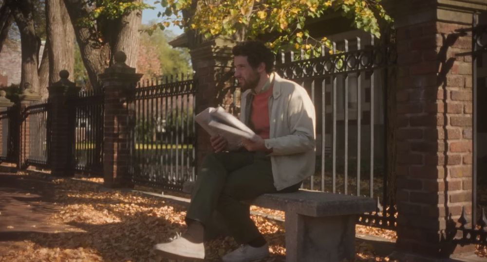 Josh O'Connor leyendo el periódico.