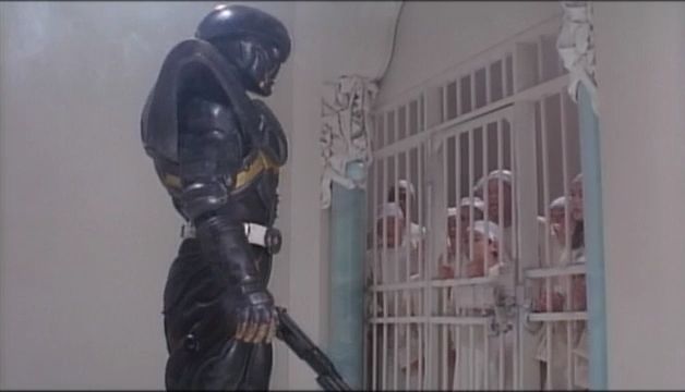 In his storming of the central administrative building of Jesus Town where its leader holed up in and wiping out its security forces, Hakaider encounters a jail cell holding those who opposed the government imprisoned. 

As he approaches the cell door everyone recoils back in fear except the one boy holding on to the door.