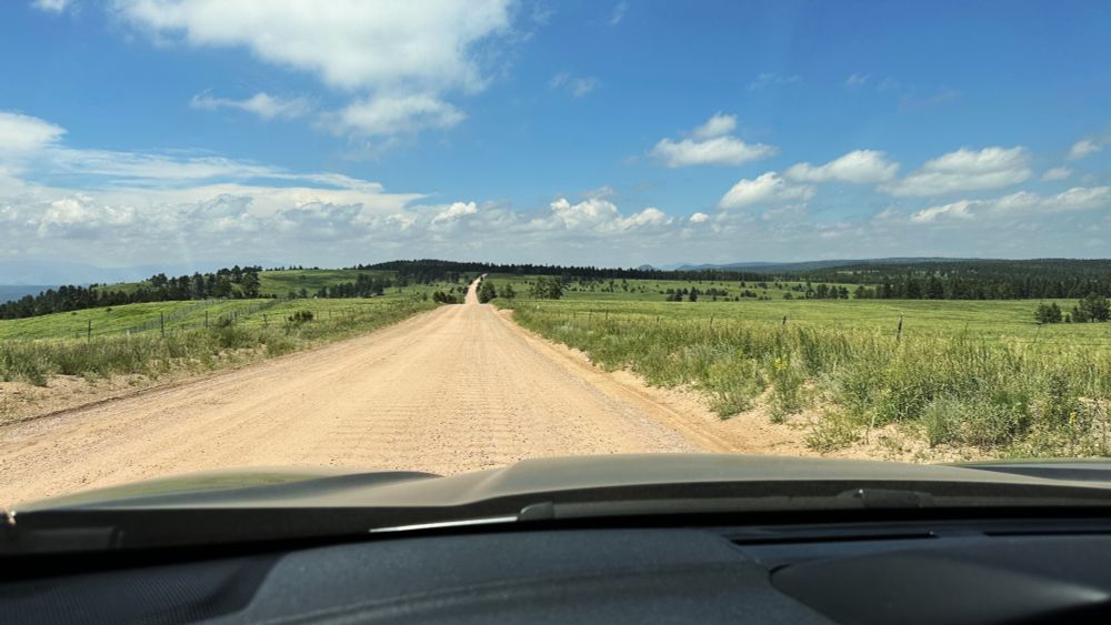 A place between places somewhere along Rampart Range Road, a dirt road without traffic, a superior place to be than either its destination or origin. What could be finer on a summer day?