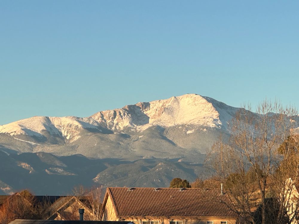 Pikes Peak glowing in first light with a fresh dusting of snow 