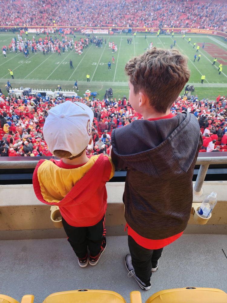 Two young boys look over the balcony at Arrowhead Stadium.