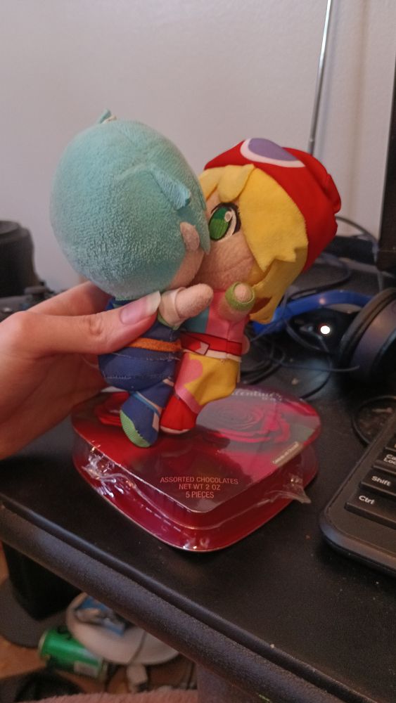 I attempted to portray Sig (left) and Amitie (right) kissing while standing on top of a box of chocolates.